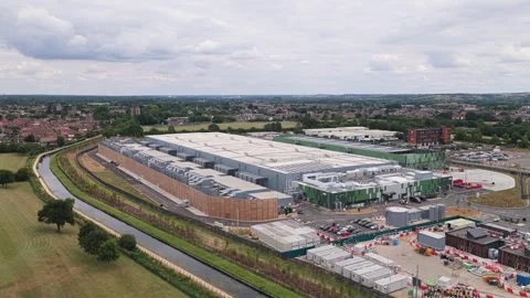 Aerial View of a Large Data Center Facility Located Near a Green Field During Stock Footage 342077428