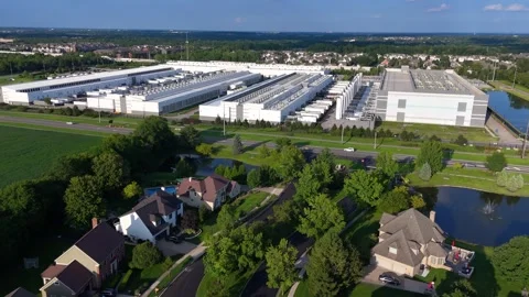 Aerial view of a large data center and cloud computing facility near a suburb Stock Footage 345670485