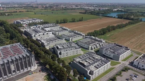 Aerial view of a large data center campus near Milan, Italy, showing secure Stock Footage 346013633
