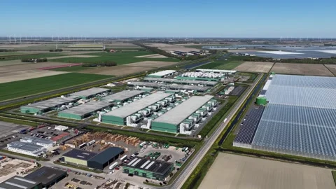 Aerial view of a large data center campus surrounded by green fields Stock Footage 346605538