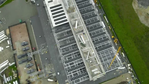 Aerial view of a large data center construction site with cooling systems being Stock Footage 347248892