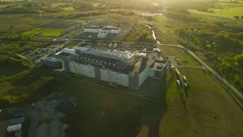 Aerial view of a large data center building under construction at sunset Stock Footage 347574701