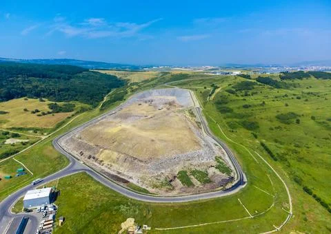 Aerial view of a large, engineered dump area surrounded by a road Stock Photos