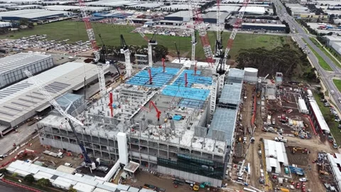 Aerial view of large industrial construction site with cranes Stock Footage 337810658