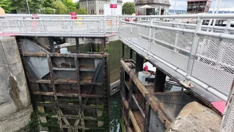 Aerial view of a large industrial lock gate opening in a canal Stock Footage 339118616