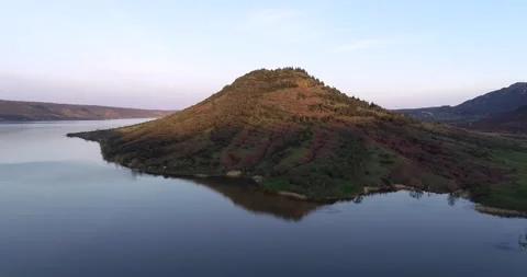 Aerial view of a large lake, pine forest, rocky mountains Beautiful reflections Stock Footage 196820280