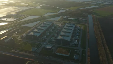 Aerial view of a large, modern data center facility in a rural landscape. The Stock Footage 332742817
