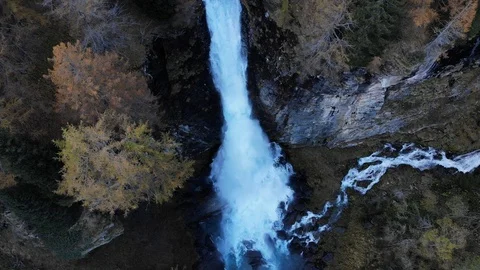 Aerial view of a large mountain waterfall in the woods with autumn colors Stock Footage 118859708