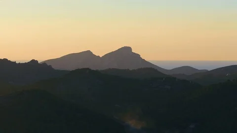 Aerial view of large mountains and smoke at sunset on INSPIRE 2 DRONE Stock Footage 101277702