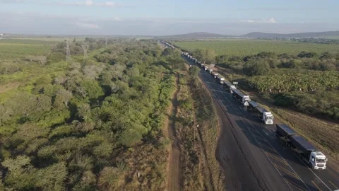 Aerial view of a large number of cargo trucks stuck in a long queue on a Stock Footage 278449015