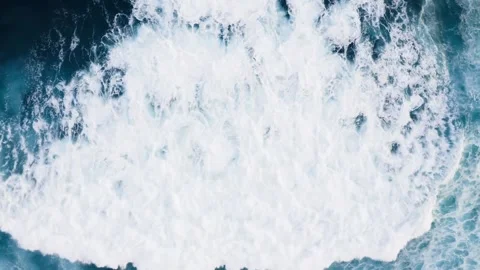 Aerial View of Large Ocean Wave Crashing with Deep Blue and White Foam Stock Footage 325807568