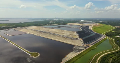 Aerial view of large open air phosphogypsum waste stack near Tampa, Florida Stock Footage 254411186