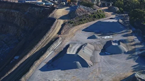 Aerial view of a large open-pit quarry revealing industrial plant Stock Footage 340122943