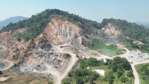 Aerial view of a large open pit mining site located in a tropical region. Stock Footage 341835335