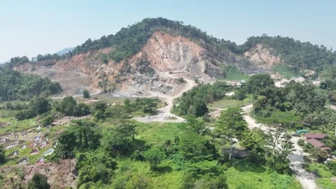Aerial view of a large open pit mining site located in a tropical region. Stock Footage 341869722