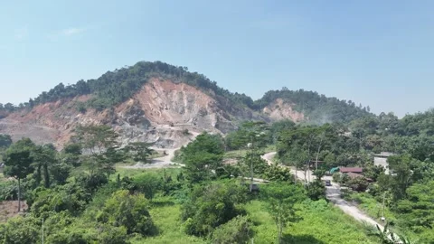 Aerial view of a large open pit mining site located in a tropical region. Stock Footage 341870964