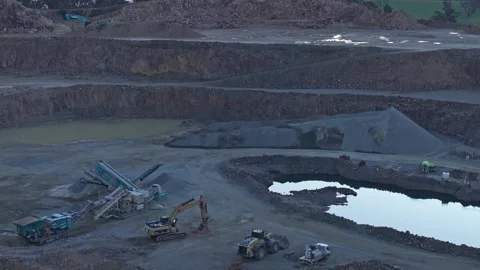 Aerial view of a large open-pit quarry with heavy machinery Video stock 342519301