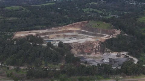 Aerial view of a large open-pit quarry mining operation Видео 343621519