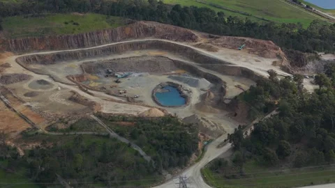 Aerial view of a large open-pit mine quarry with machinery Видео 343621766