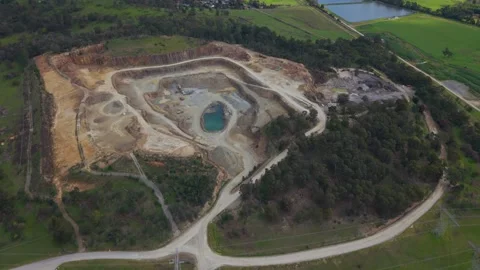 Aerial view of a large open-pit mine quarry with a lake Видео 343623556