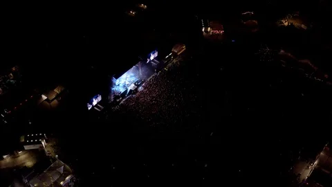 Aerial view of large outdoor concert festival at night Stock Footage