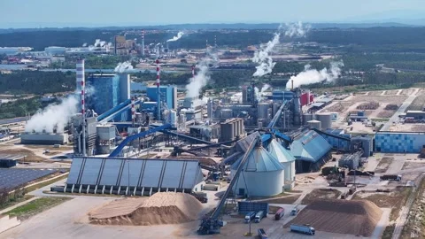 Aerial view of a large paper mill industrial complex producing pollution Stock Footage 339674194