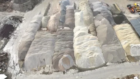 Aerial view of large piles of various colored sand and gravel materials 스톡 동영상 331379944