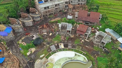 Aerial view of a large resort and swimming pool under construction in the Stock Footage 331089442