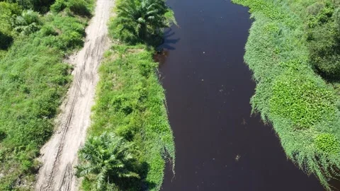 Aerial view of a large river on the edge of a highway, the water looks dark.. Stock Footage 321846502
