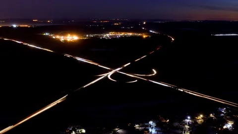 Aerial view of a large road junction at night, timelapse. Video stock 107678539