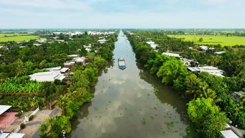 Aerial view of a large sand cargo boat navigating on a Mekong Delta river Vídeos de archivo 336040643