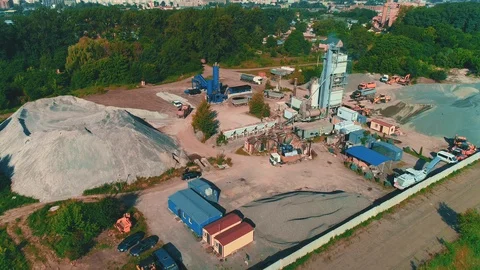 Aerial view of large sand piles and launching of building. 4K. Stock Footage 113085104