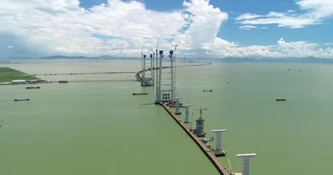 Aerial View of Large Scale Bridge Construction Project Over Open Water in China Vídeos de archivo 342017825