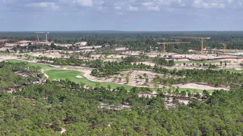 Aerial view of large-scale coastal resort and golf course development with Stock Footage 324010551
