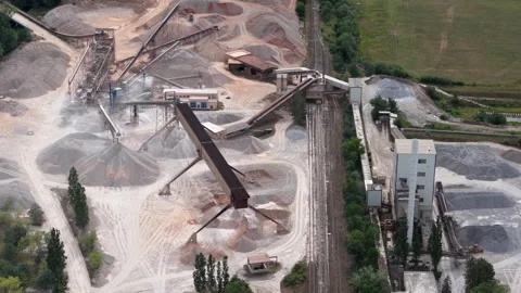Aerial view of a large-scale quarry processing plant with piles of aggregate Stock Footage 342703244