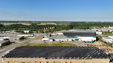 Aerial View of Large-Scale Rooftop Solar Panel Arrays on Building Stock Photos