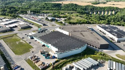 Aerial View of Large-Scale Rooftop Solar Panel Arrays on Building Stock Photos