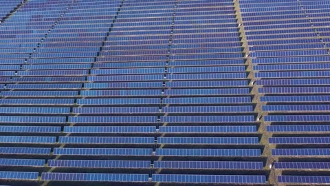 Aerial View of Large Scale Solar Farm with Extensive Panel Rows Stock Footage 329852925