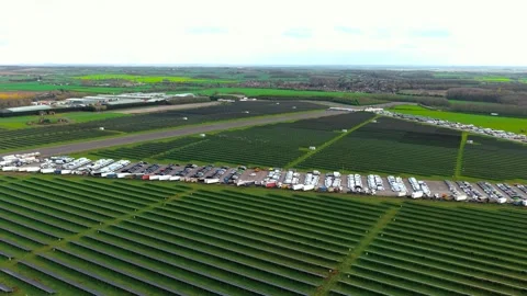 Aerial view of large scale solar farm with organized photovoltaic arrays and Stock Footage 332219222