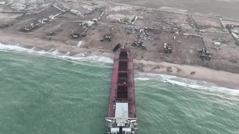 Aerial View Large Ship Beached At Gadani Breaking Yard. Pull Back Shot Stock Footage 254695019