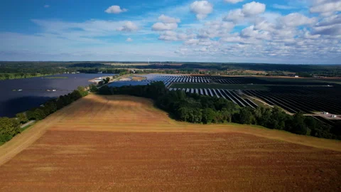 Aerial View Of Large Solar Array Farm Surrounding  Wheat Field. Dolly Left Stock Footage 223128245