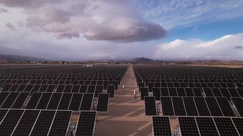 Aerial view of large solar farm with vast array of photovoltaic panels in d.. Video stock 337807731
