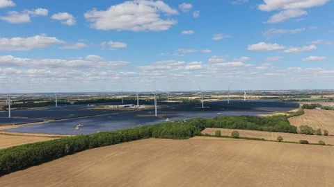 Aerial View of a Large Solar Farm With Wind Turbines in the Countryside Stock Footage 346422570
