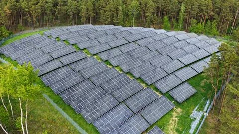 Aerial View of Large Solar Panel Farm in Forest Landscape Fotos Stock