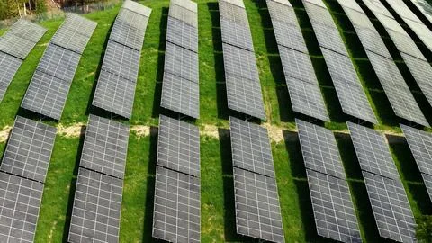 Aerial View of Large Solar Panel Array on Green Meadow 写真素材