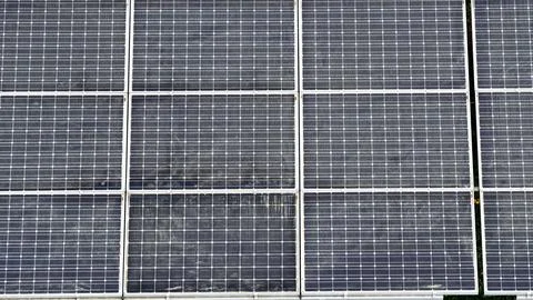 Aerial View of Large Solar Panel Array in Green Landscape Fotos Stock
