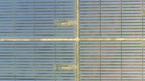 Aerial view of large solar panels at solar farm at sunrise in sunny spring Stock Footage 165663596