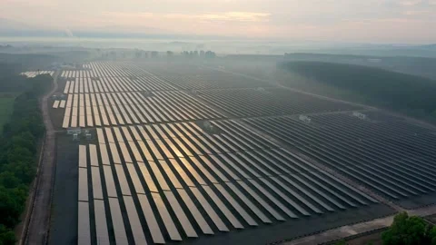 Aerial view of large solar panels at solar farm at sunrise in sunny spring. S Video stock 169088465