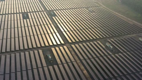 Aerial view of large solar panels at solar farm at sunrise in sunny spring. S Stock Footage 169089434
