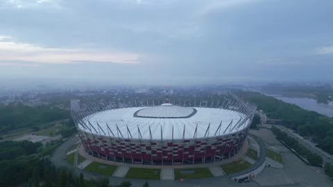 Aerial view of a large stadium with a unique exterior design, surrounded Stock Footage 277879522